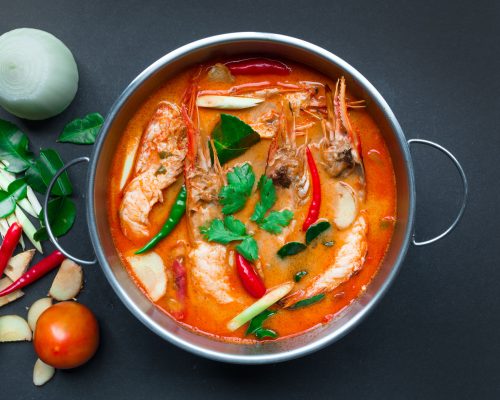 48901818 - tom yum goong,thai food, top view on black background